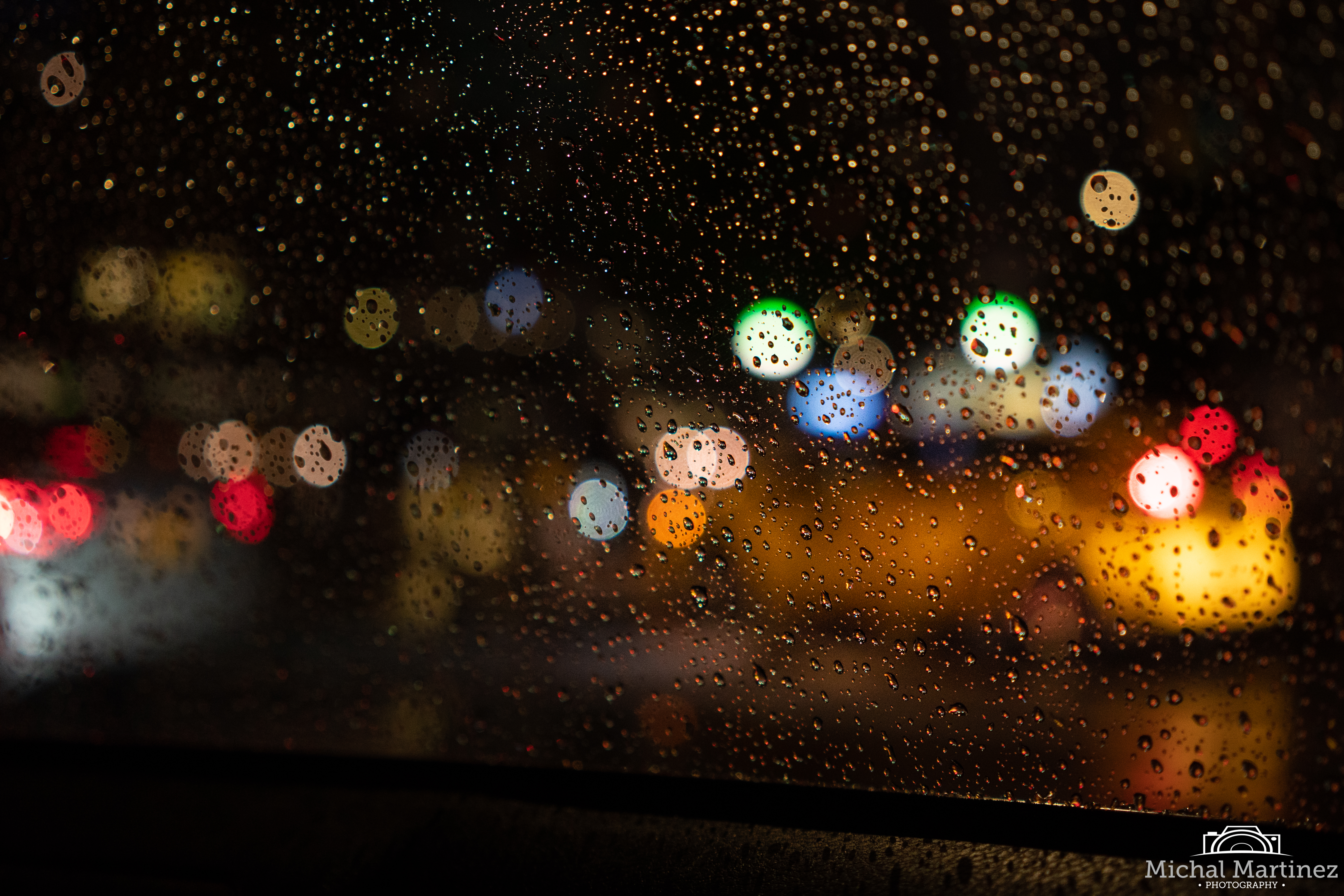 Image of NYC car and car lights through rainy car window